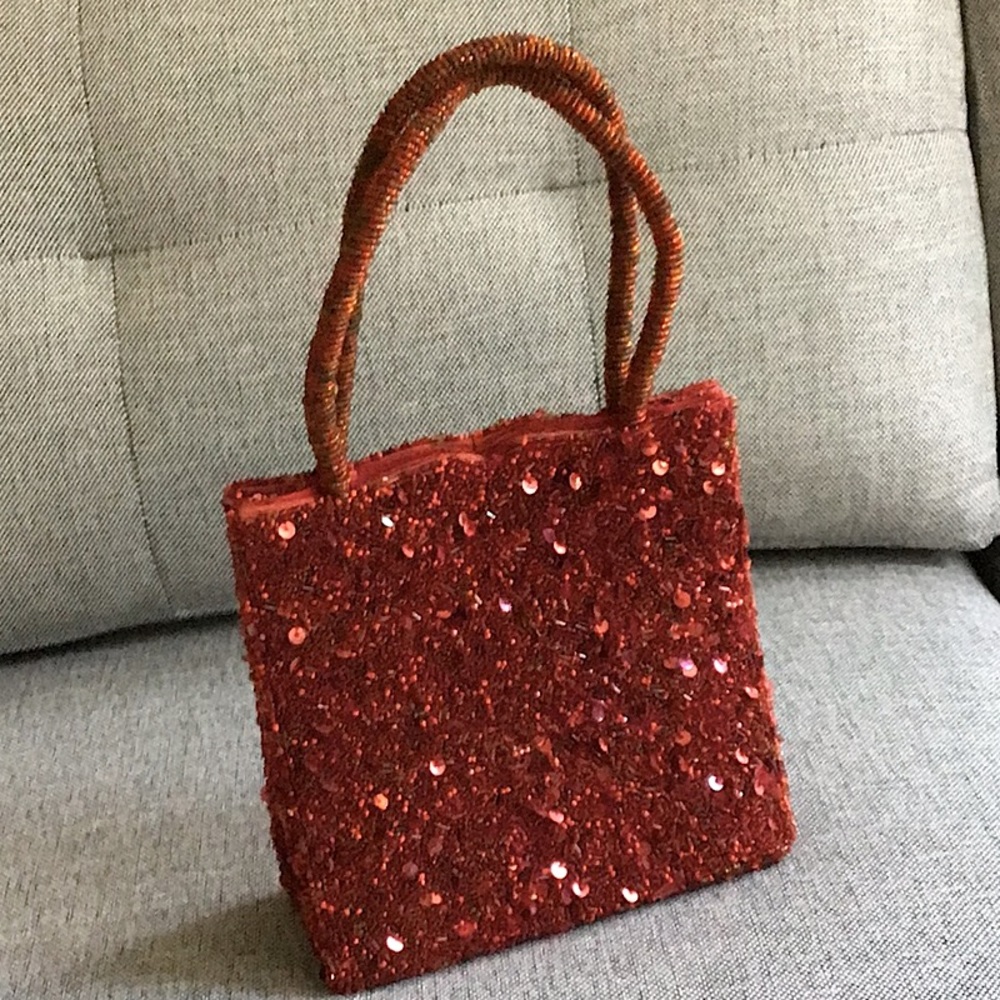 Red sequined handbag with beaded handles